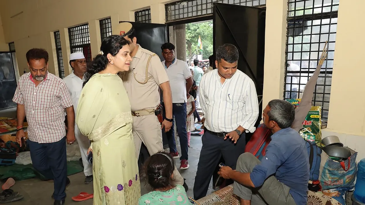 Noida Authority CEO Ritu Maheshwari interacts with support staff rescued from flood-affected villages