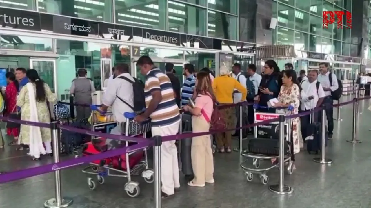 Passengers wait outside the Kempegowda International Airport in Bengaluru after services were affected by ‘server outage’