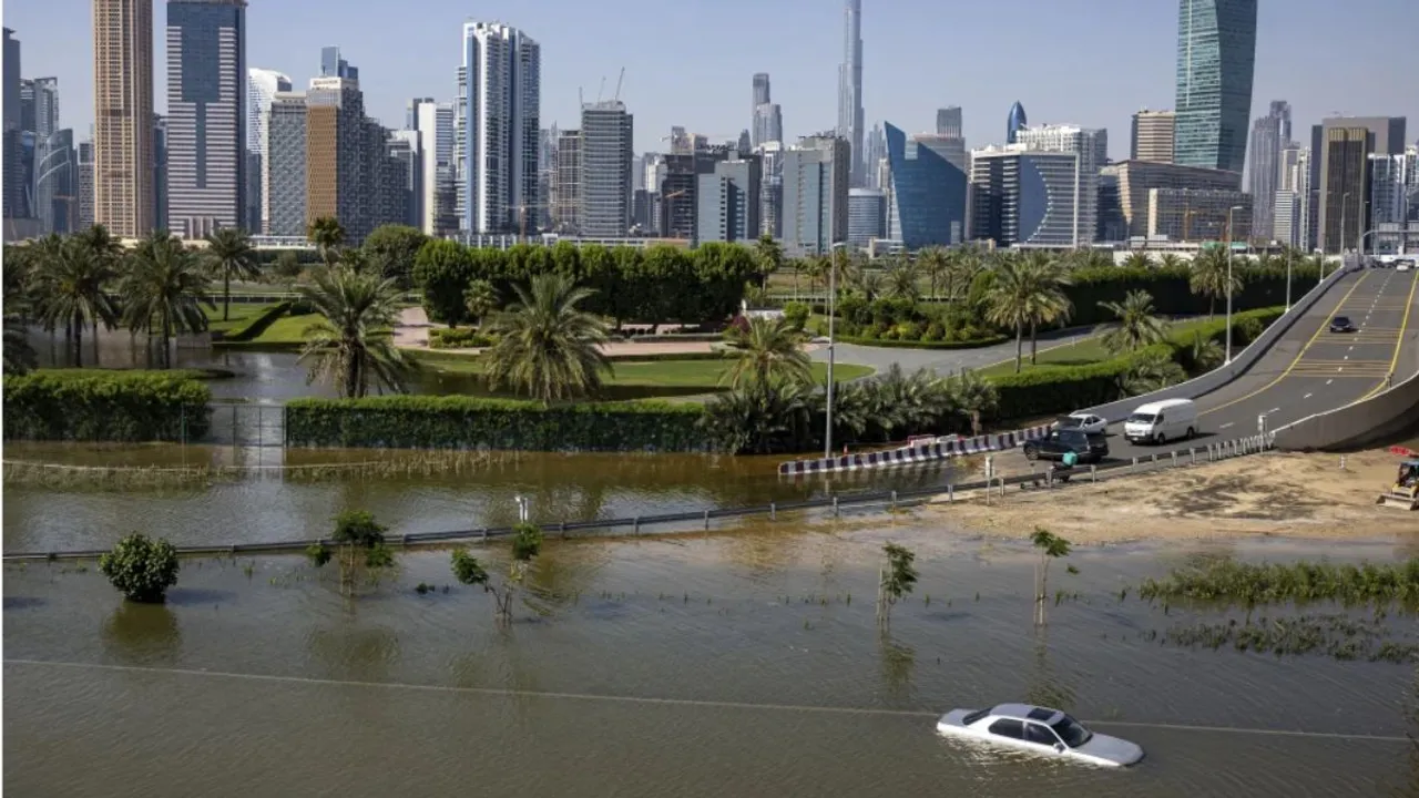 An abandoned vehicle sits in floodwater near the Burj Khalifa in Dubai, UAE, after heavy rain on April 18, 2024. 