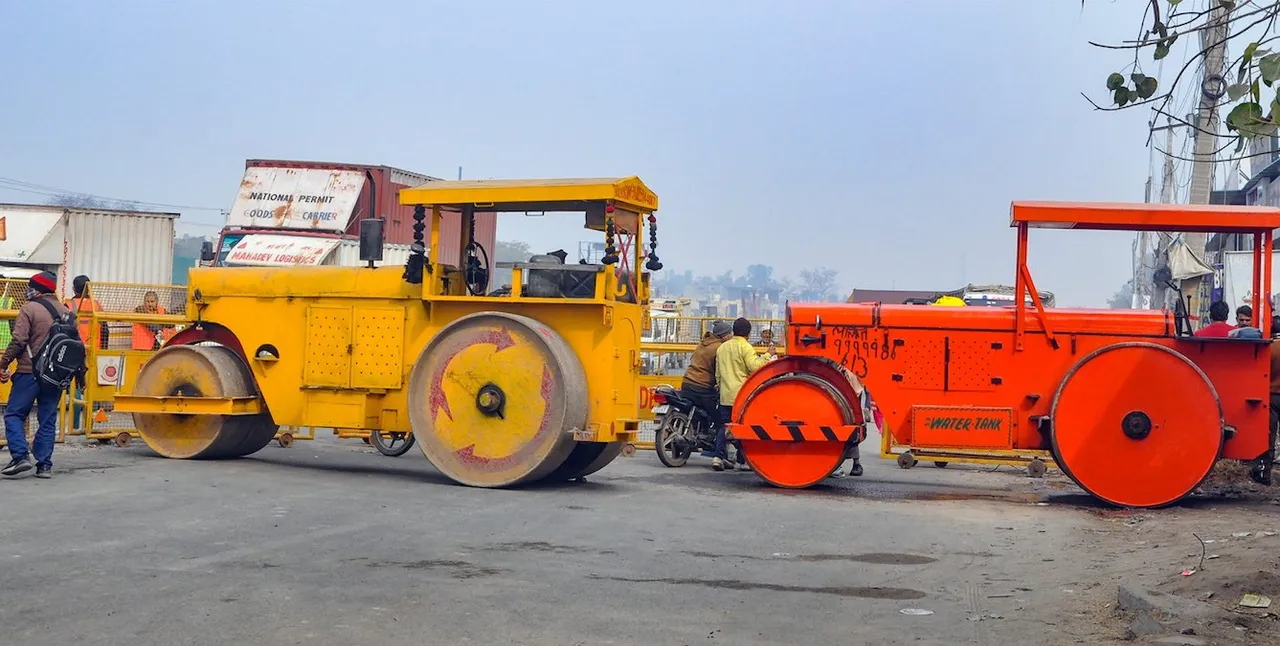 Road rollers, acting as a barricade, parked near Singhu border in view of farmers' 'Delhi Chalo March', in Sonipat district, Monday, Feb. 12, 2024.