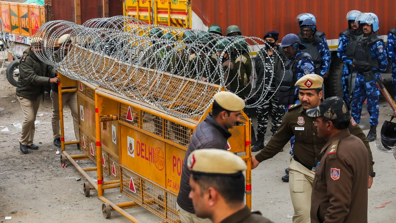 Police install barricades and concertina wires near the Tikri border in view of farmers' 'Delhi Chalo' march, near New Delhi