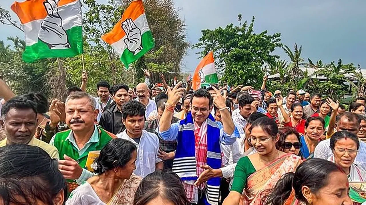 Congress candidate Gaurav Gogoi dances with supporters during an election campaign ahead of Lok Sabha polls, in Majuli, Assam