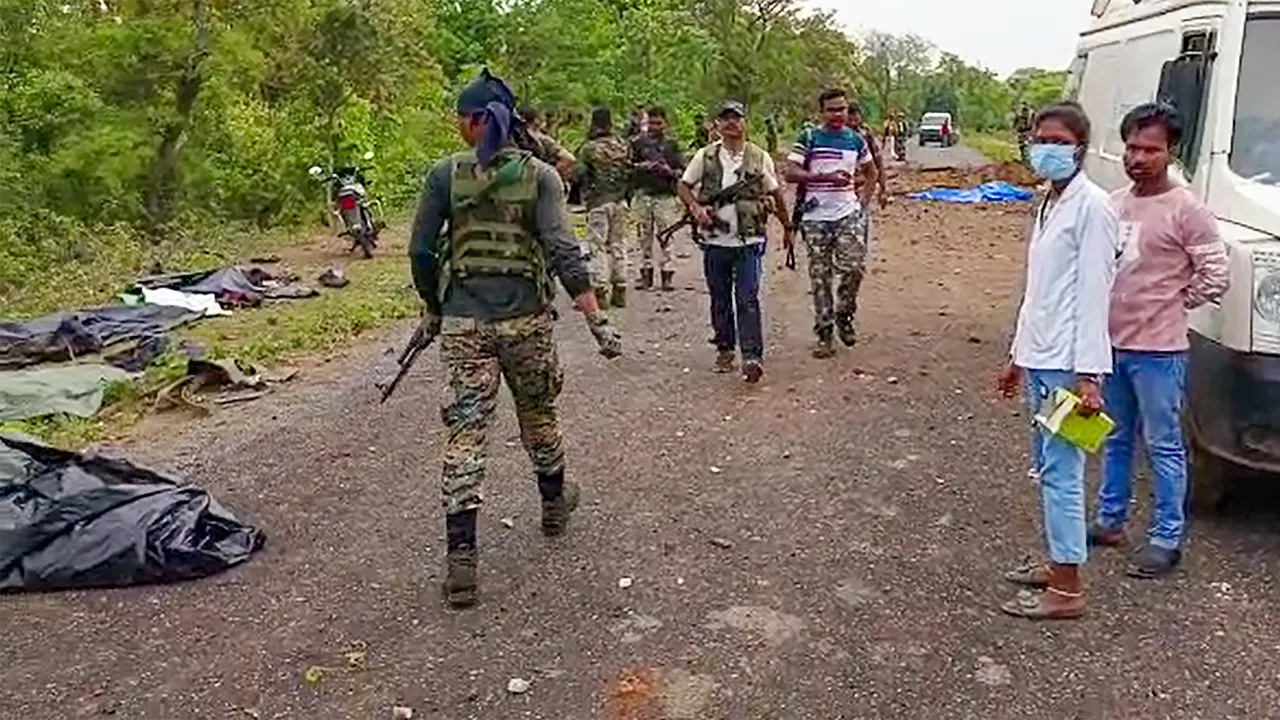 Security personnel at the site after at least ten police personnel and a driver were killed in a blast carried out by Naxalites in Chhattisgarh's Dantewada district April 26