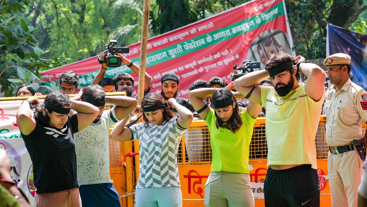 Wrestlers wear black bands during their ongoing protest against Wrestling Federation of India (WFI) chief Brij Bhushan Sharan Singh, at Jantar Mantar