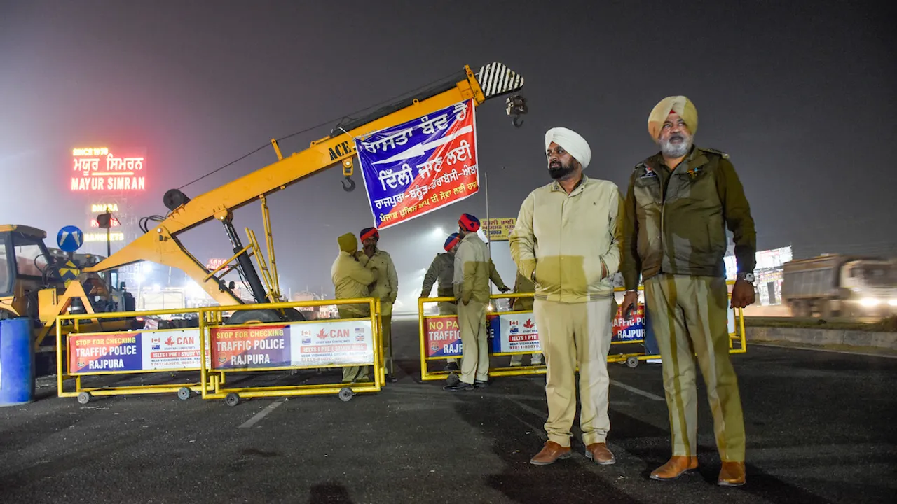 Police personnel stand guard during traffic restrictions near Shambhu Border ahead of the scheduled march by the protesting farmers towards Delhi, at Rajpura, in Patiala district, Monday, Feb. 12, 2024.