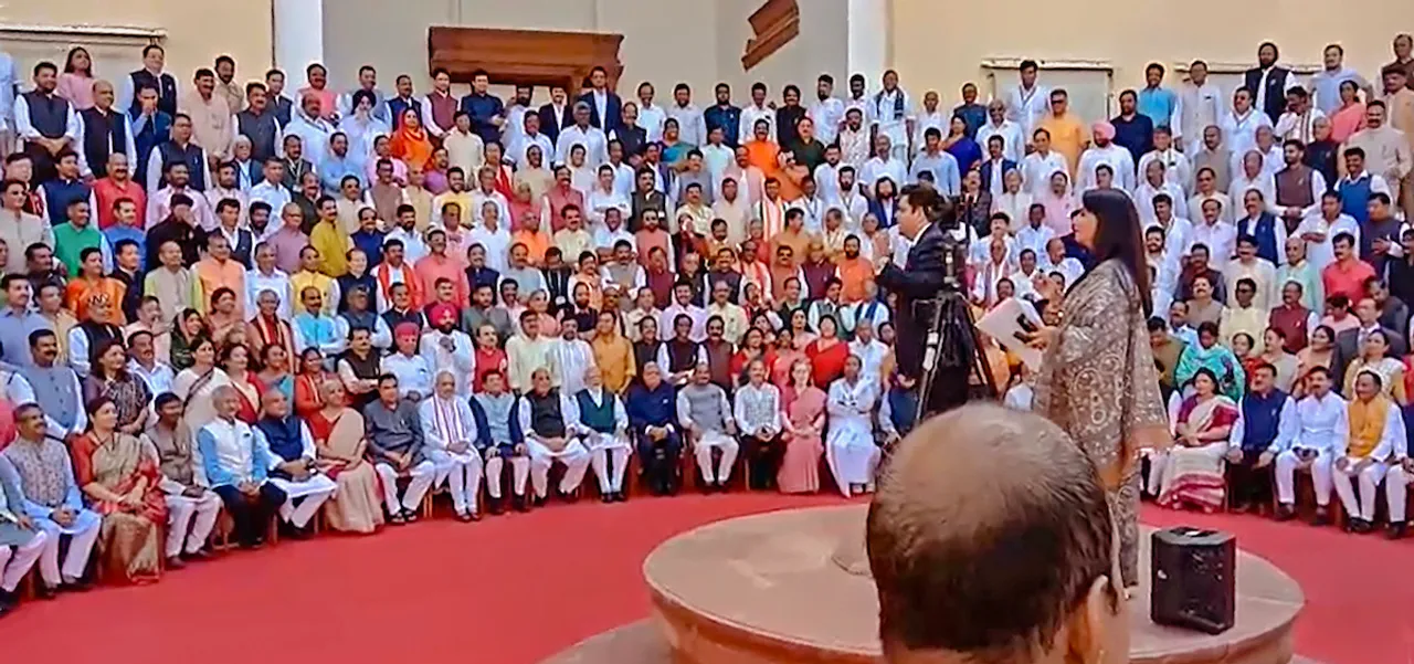 Lok Sabha and Rajya Sabha members pose for a group photograph at the old Parliament House complex during a special session, in New Delhi, Tuesday, Sept. 19, 2023.