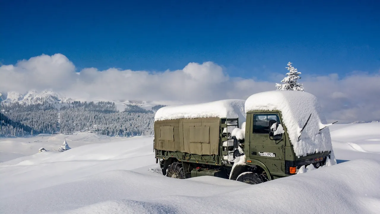An army vehicle covered in snow at Gulmarg after fresh snowfall, in Baramulla district