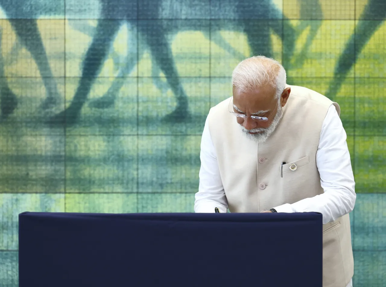 Prime Minister Narendra Modi signs the visitor’s book during his visit to the Hiroshima Peace Memorial Museum, in Hiroshima, Japan
