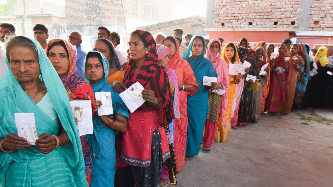 Voters show their identity cards as they wait in a queue at a polling station to cast their votes during the sixth phase of the Lok Sabha elections, in Vaishali district, Saturday, May 25, 2024