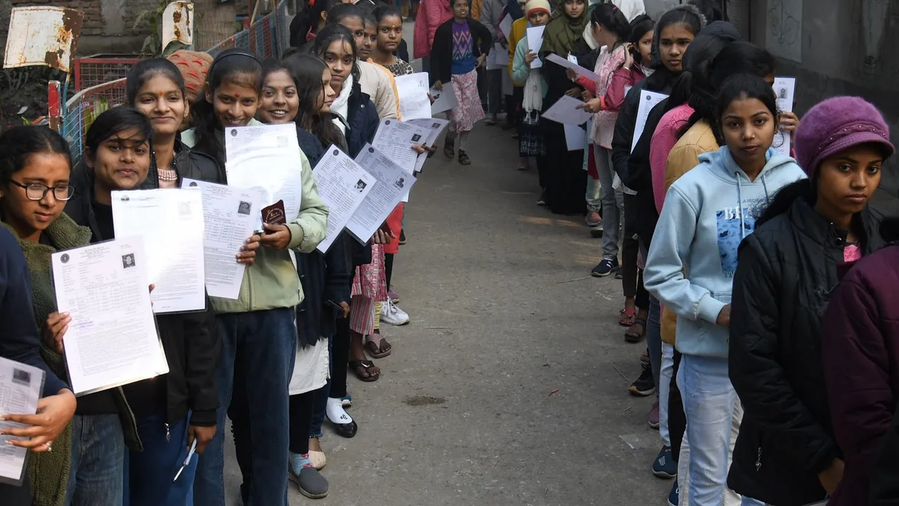 Students show their admit cards as they wait to enter the examination hall to appear in the class 12 (intermediate) exam of the Bihar School Examination Board (BSEB), in Patna