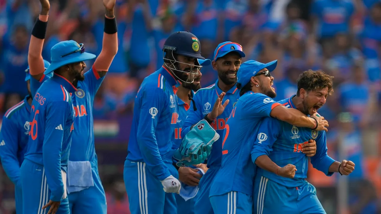 Kuldeep Yadav celebrates with teammates after a successful review for an LBW of Pakistan's Saud Shakeel during the ICC Men's Cricket World Cup 2023 match