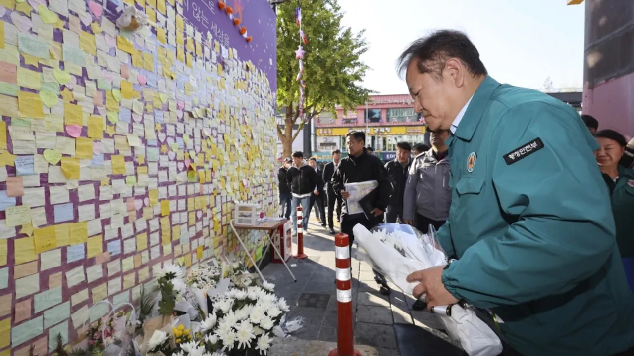 South Korean Interior and Safety Minister Lee Sang-min places flowers to pay his condolence to the victims of the Oct. 29, 2022 crush, in front of the messages for victims in Seoul, South Korea, Saturday, Oct. 28, 2023.