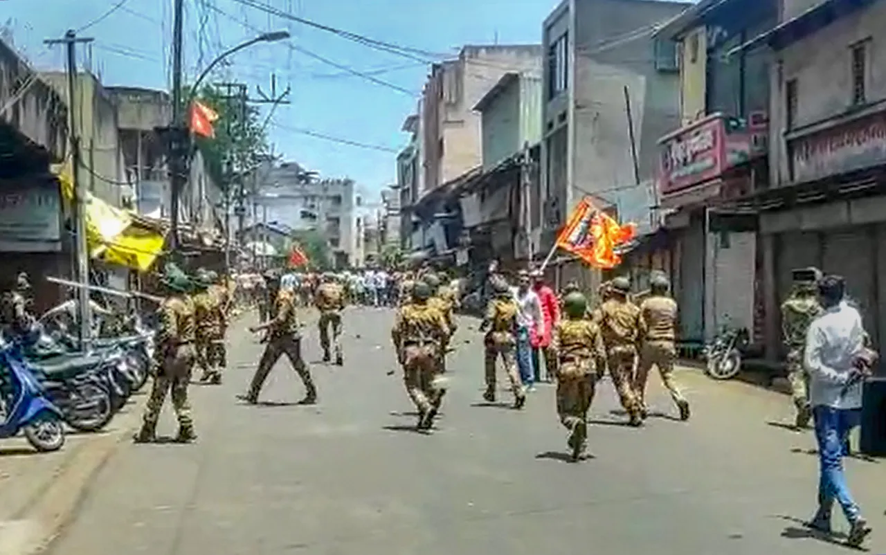 Security personnel disperse agitators objecting to the alleged use of Tipu Sultan’s image along with an objectionable audio message as social media “status” by some locals, in Kolhapur