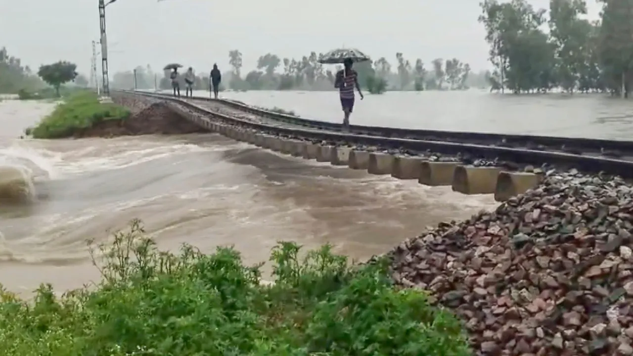 A section of a railway track hangs in the air after the ground beneath it got washed away in rainwater, in Pilibhit, Monday, July 8, 2024.