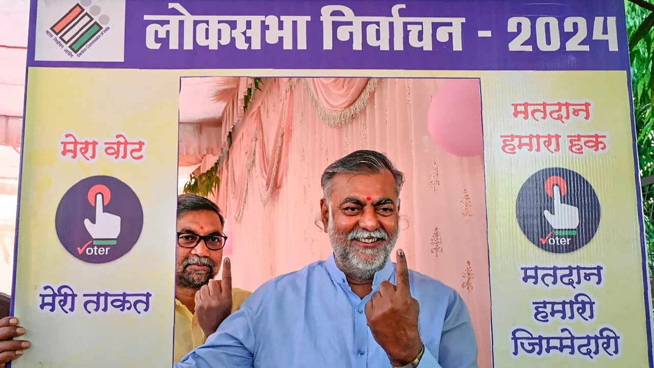 Madhya Pradesh minister and BJP leader Prahlad Patel shows his inked finger at a selfie stand after casting his vote for the second phase of Lok Sabha elections, in Narsinghpur, Friday, April 26, 2024