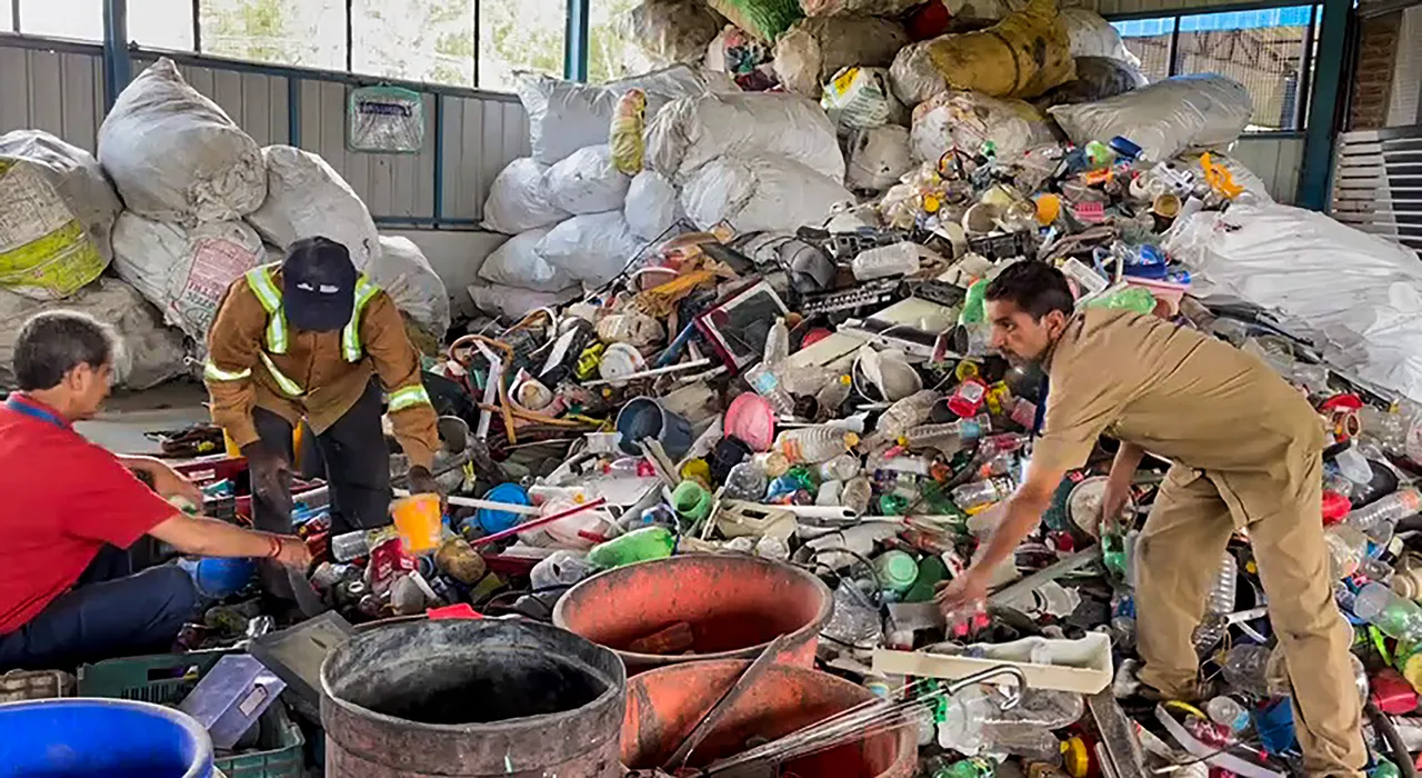 Employees of a Material Recovery Facility (MRF), also known as 'Swachhta Kendra', sort recyclable materials from garbage collected from multiple cleanliness drives, in Jammu
