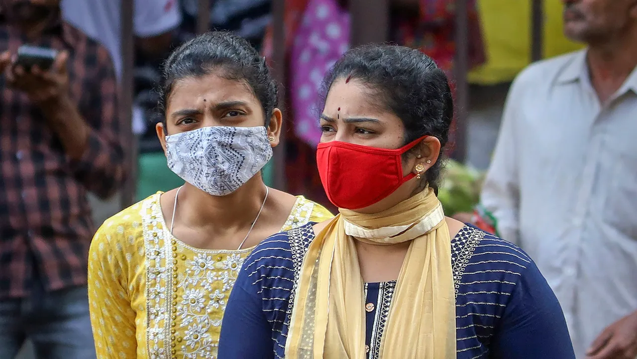 People wearing face masks as a precautionary measure after cases of COVID-19 sub-variant JN.1 were detected in the country, in Bengaluru