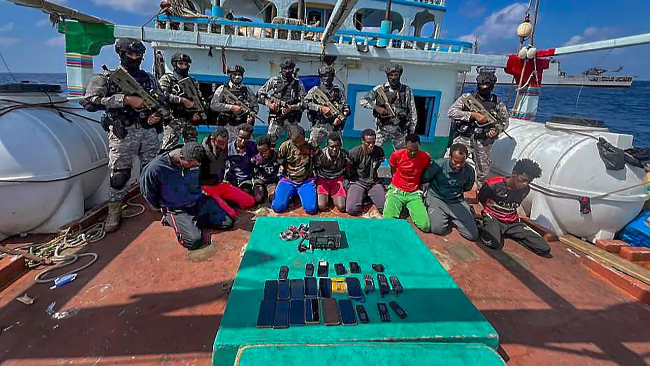 Officials with the captured pirates during an anti-piracy operation by INS Sumitra, rescuing 19 Pakistani Nationals