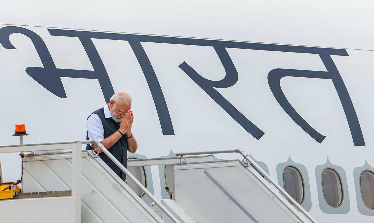 Prime Minister Narendra Modi gestures as he leaves for his visit to Paris, in New Delhi, Thursday.jpg