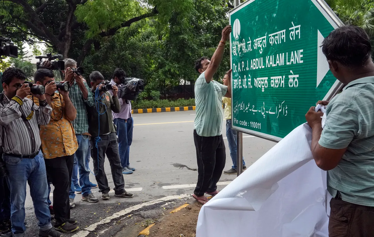 NDMC workers unveil a signboard bearing 'Dr APJ Abdul Kalam Lane' following the renaming of the Aurangzeb Road after the former president, in New Delhi