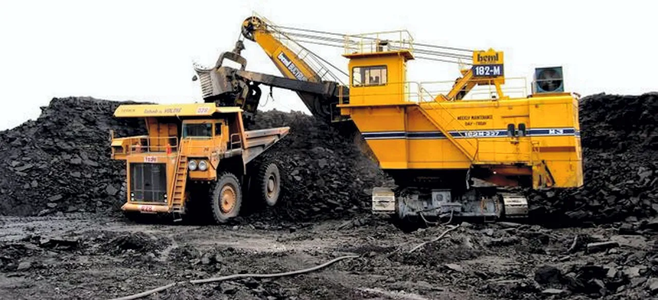 A heavy machinery excavating coal at a mining site