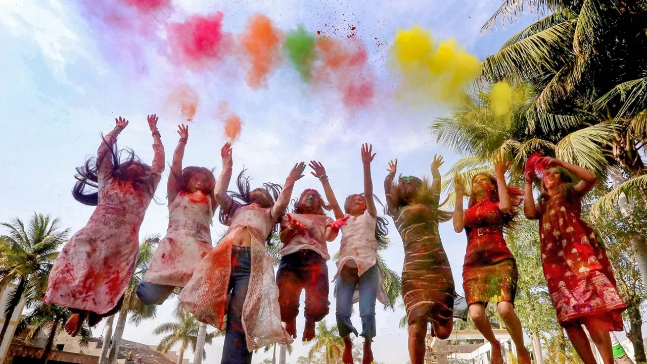 Young women play Holi in Bhopal, Friday, March 22, 2024