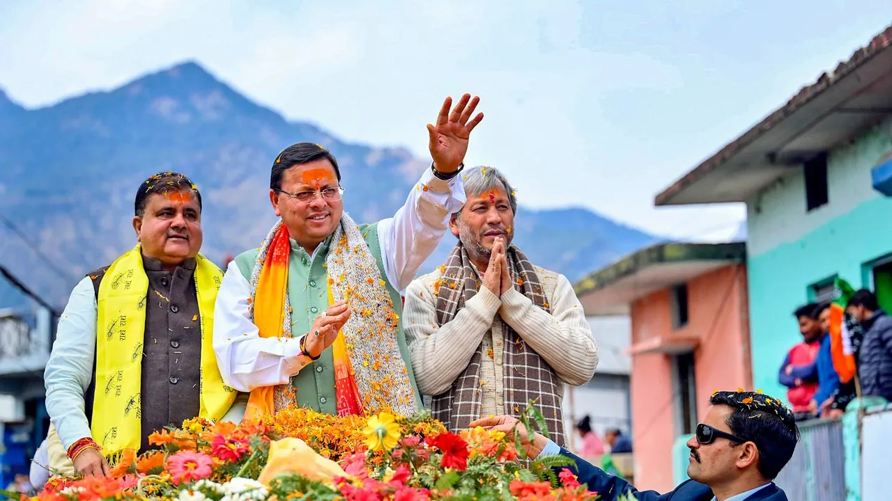 Uttarakhand Chief Minister Pushkar Singh Dhami waves at supporters during a roadshow at Gopeshwar, in Chamoli district