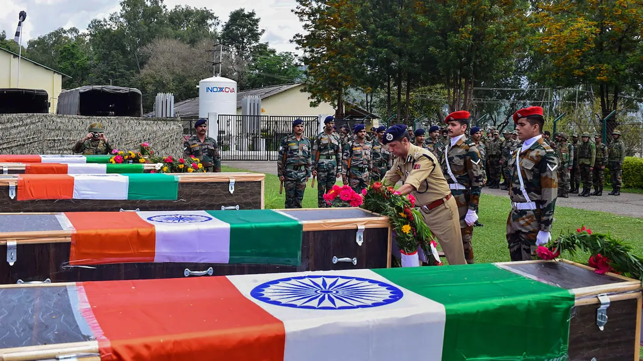 Security personnel lay a wreath near the mortal remains of 5 soldiers on April 21, who were killed in a terrorist attack in Poonch district