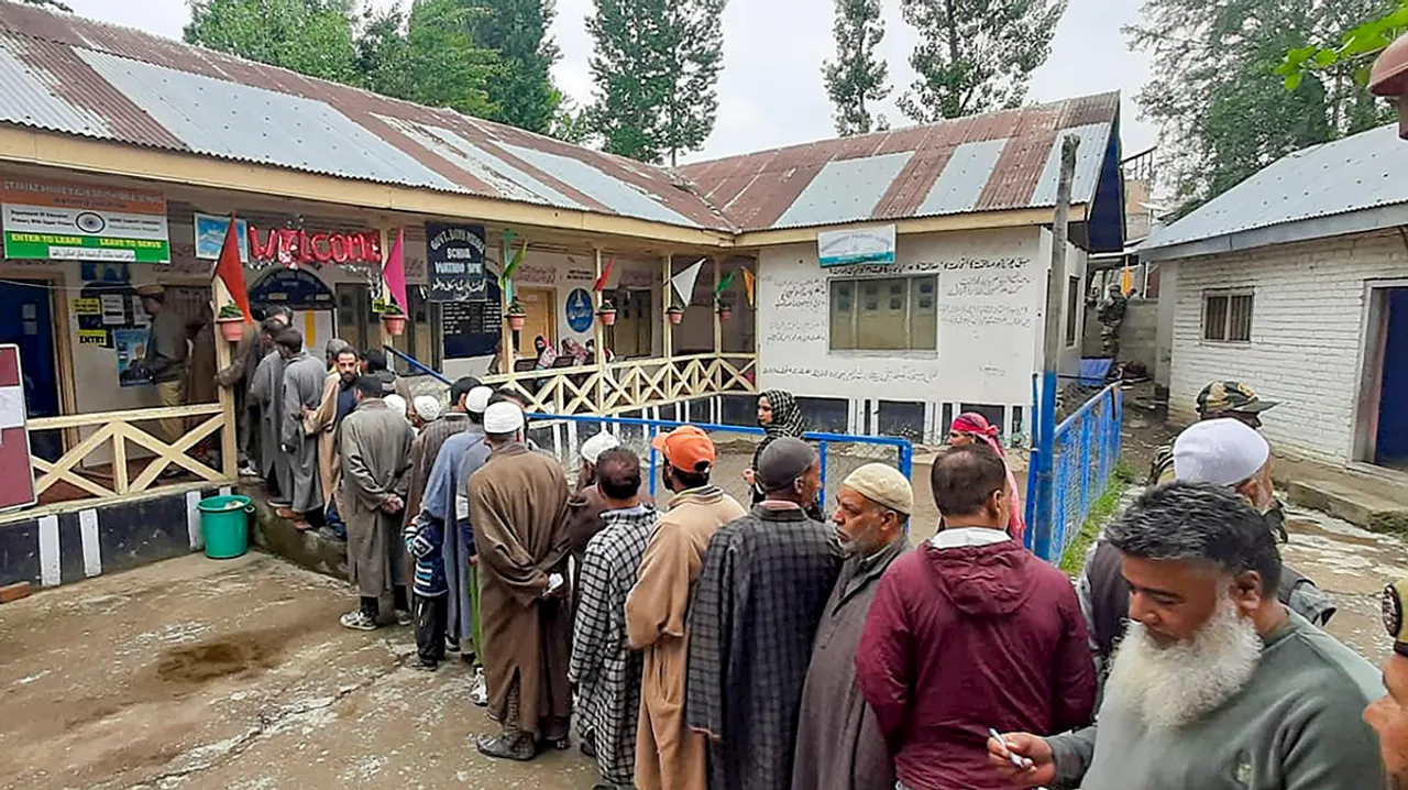 People wait in a queue to cast their votes at a polling booth during the fourth phase of General Elections-2024 in Srinagar, J & K, Monday, May 13, 2024.