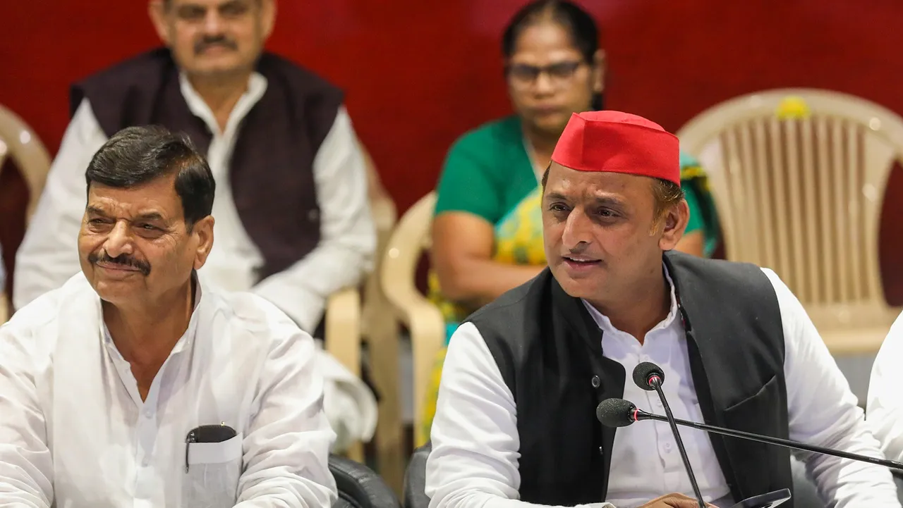 Samajwadi Party president Akhilesh Yadav with Shivpal Singh Yadav addresses a press conference at the party office, in Lucknow