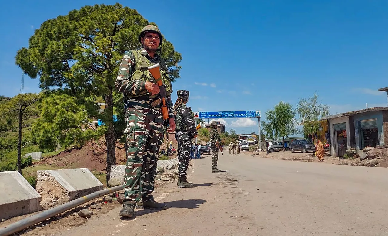 Security personnel near the site of an encounter with terrorists in Kandi area of Rajouri district