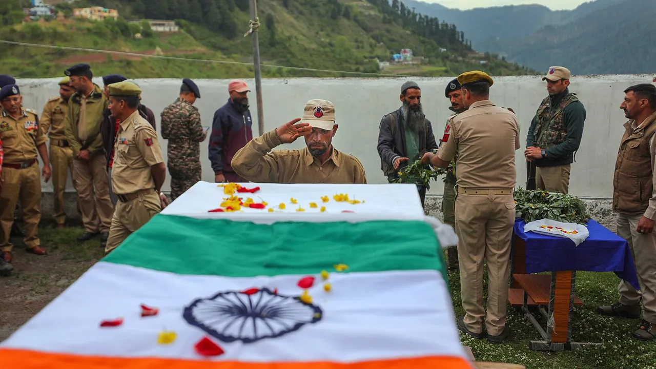 Security personnel paying respect to the mortal remains of Village Defence Guards (VDG) member Mohammad Sharif, who laid down his life while fighting terrorists in the Basantgarh area, in Udhampur district, Sunday, April 28, 2024