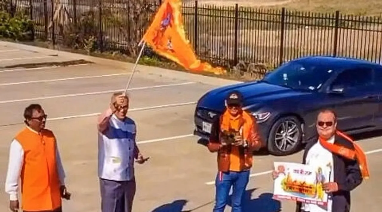 Devotees wave saffron flag and chant 'Jai Shree Ram' slogan as they celebrate the inauguration of Ram Mandir, in Houston.