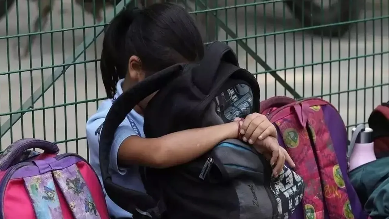 Girl with a school bag in her lap