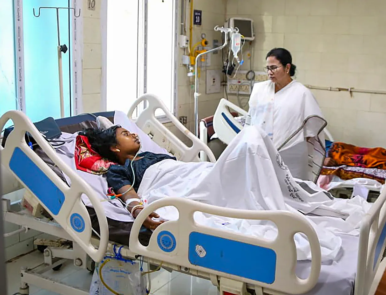 West Bengal Chief Minister Mamata Banerjee meets a passenger injured in the triple-train accident, at a hospital in Cuttack