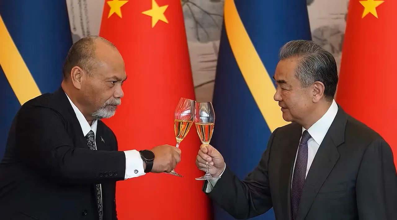 Chinese Foreign Minister, Wang Yi, and Minister of Foreign Affairs and Trade of Nauru, Lionel Aingimea, toast after reestablishing diplomatic relations between the two countries