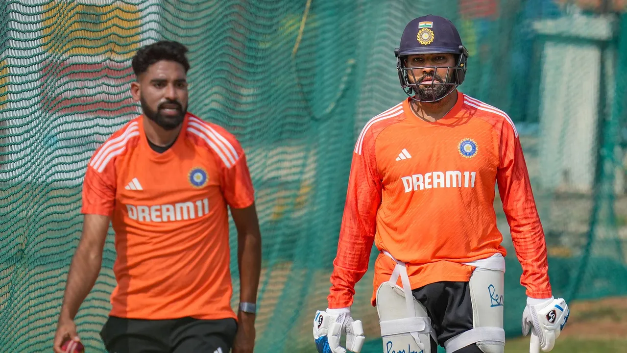 India's captain Rohit Sharma with teammate Mohammed Siraj during a practice session