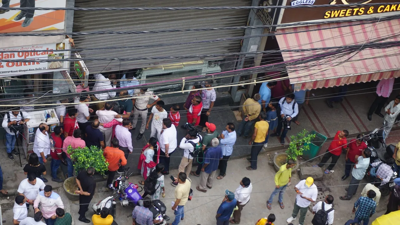 Police personnel investigate at Umrao Singh Jewellers shop after jewellery worth 25 crores were stolen from the shop, at Bhogal area in New Delhi