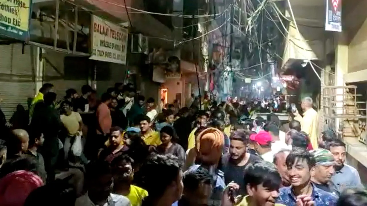 People gather outside their homes after tremors were felt due to an earthquake in Delhi-NCR