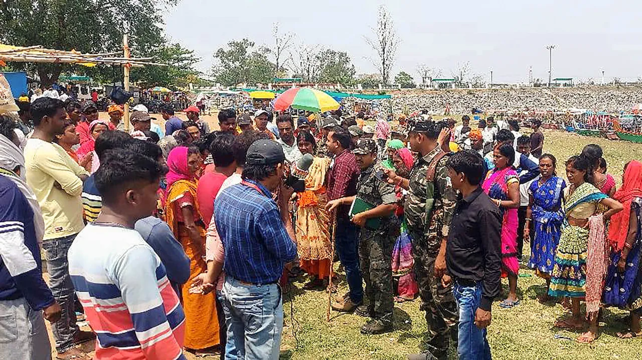 Security personnel with locals at Patratu lake after a clash between two groups of boatmen and their family members in Ramgarh district on April 9