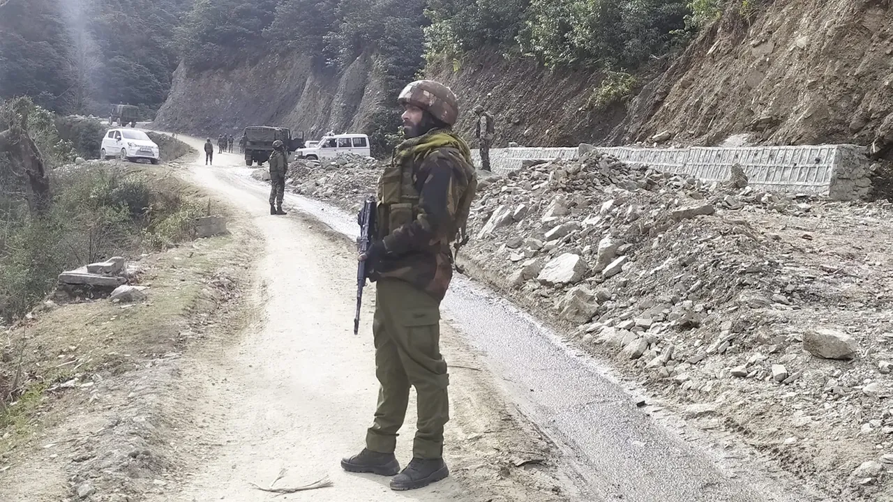 Army personnel stand guard near the site where two Army vehicles were ambushed by terrorists on Thursday, in Poonch