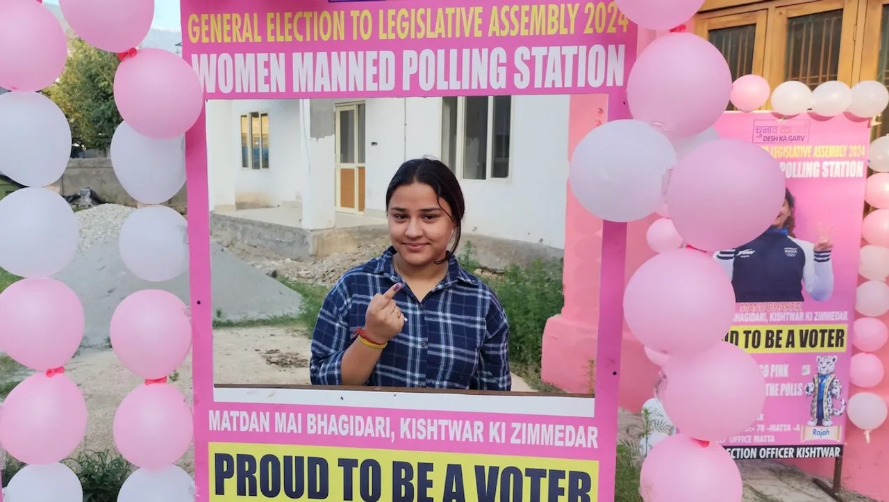 A voter shows her finger marked with indelible ink after casting vote at a women managed polling station during the first phase of Jammu and Kashmir Assembly elections, in Kishtwar district.