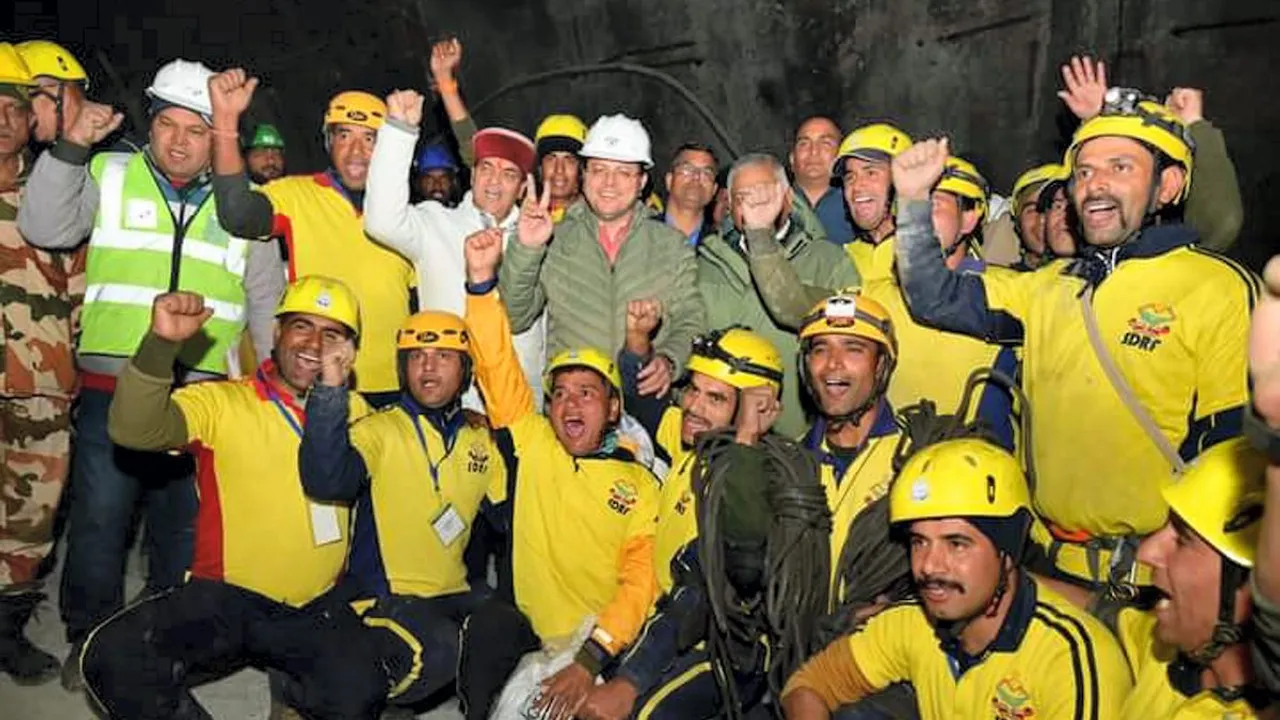 Pushkar Singh Dhami and Union Minister of State VK Singh with rescue officials after the successful evacuation of 41 workers from the collapsed Silkyara Tunnel, in Uttarkashi, Tuesday, Nov. 28, 2023.