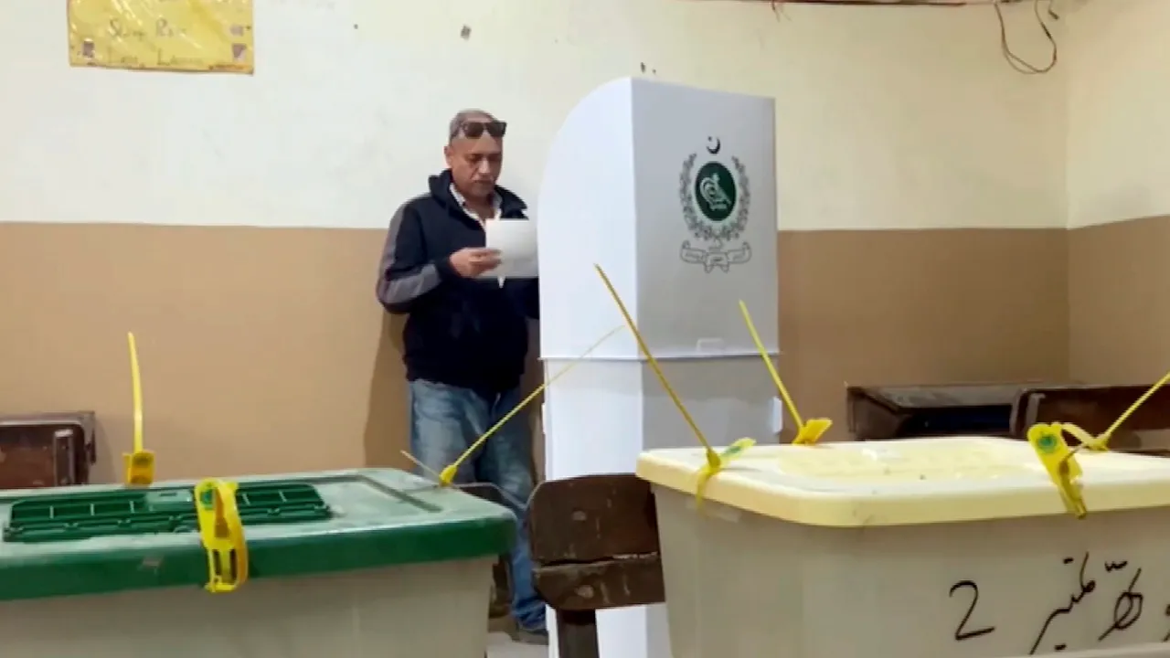A man casts vote during the general elections, in Karachi