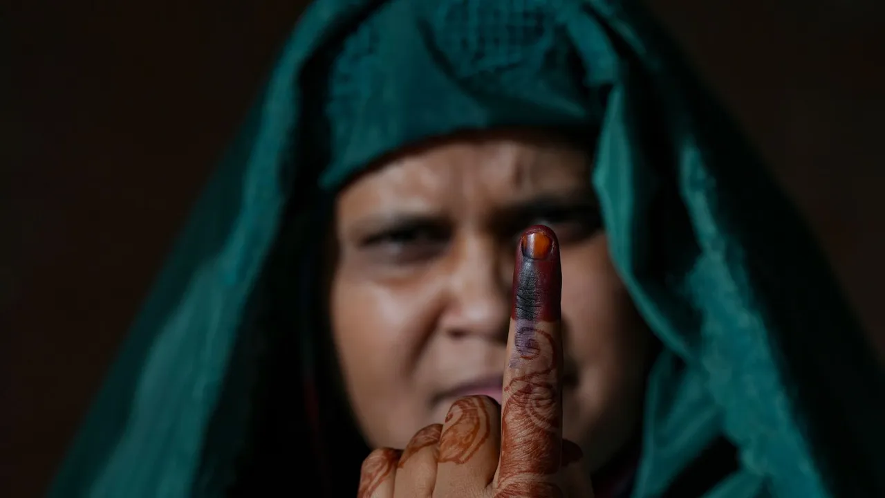 A Muslim woman shows her finger marked with indelible ink after casting her vote for the first phase of Lok Sabha elections, at a polling station in Kairana, Friday, April 19, 2024