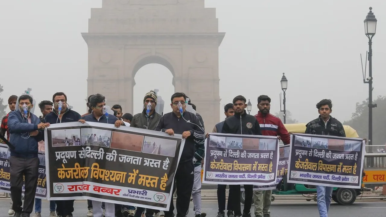 Delhi BJP workers wearing oxygen masks protest near the India Gate against Arvind Kejriwal-led state government and the allegedly rising air pollution, in New Delhi, Saturday, Dec. 30, 2023