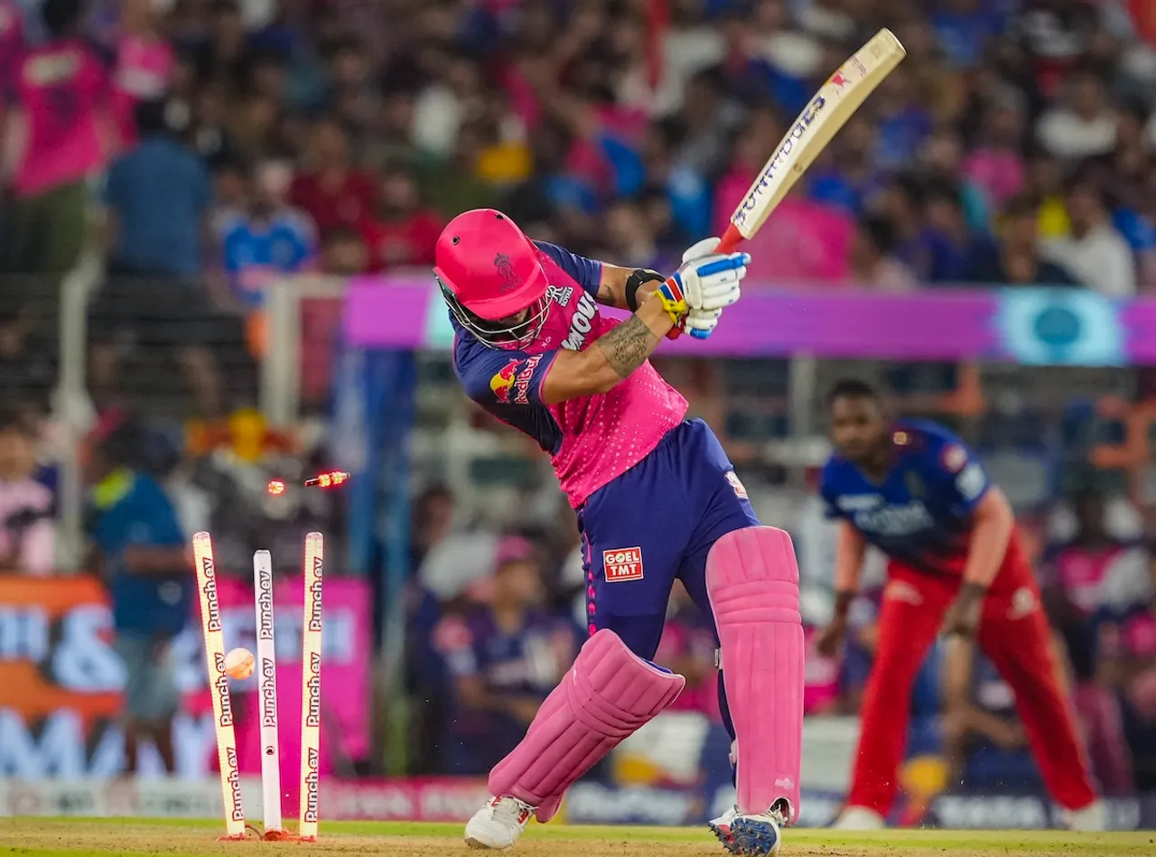 Rajasthan Royals' Riyan Parag is bowled out by Royal Challengers Bengaluru's player Mohammed Siraj during the Indian Premier League (IPL) 2024 T20 cricket match between Royal Challengers Bangaluru and Rajasthan Royals at the Narendra Modi Stadium, in Ahmedabad, Wednesday, May 22, 2024.