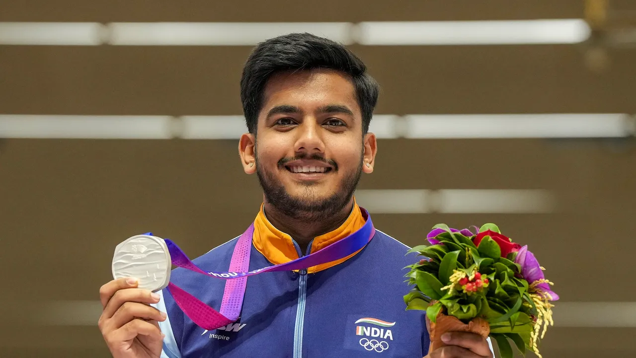 Silver medalist Indian shooter Aishwary Pratap Singh Tomar poses with the medal after the finals of Men's 50m Rifle 3 Positions event at the 19th Asian Games, in Hangzhou, China
