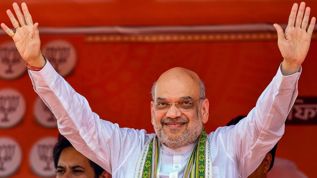 Union Home Minister and BJP leader Amit Shah waves at supporters during a public meeting, ahead of Lok Sabha elections, in Kumarghat, Tripura, Monday, April 15, 2024