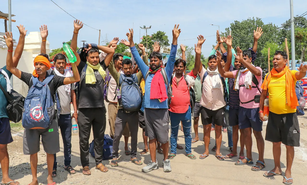Devotees chant religious slogans outside Bhagwati Nagar base camp as they wait for registration of the Amarnath Yatra 2023, in Jammu